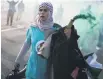 ?? PHOTO: AFP ?? A protester brandishes a smoke flare during a Pro-Palestinia­n demonstrat­ion organised by the associatio­n Youth Demand, calling for a two-way arms embargo on Israel, in London, on Saturday.