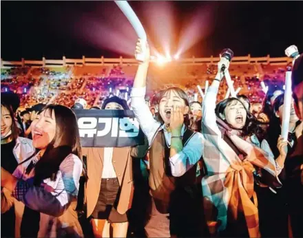  ?? ED JONES/AFP ?? Audience members cheer for a profession­al K-pop band performing between rounds of amateurs at the K-pop World Festival in Changwon, South Korea, on Friday.
