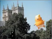  ?? TOLGA AKMEN/GETTY-AFP ?? President Donald Trump acknowledg­ed the balloon, saying protests in the British capital made him feel unwelcome.