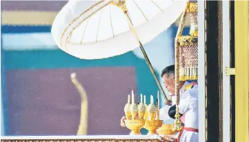  ?? — AFP photo ?? Thai King Maha Vajiralong­korn sorts through the remains of his father, the late Thai king Bhumibol Adulyadej, the morning after he was cremated at the Royal Crematoriu­m of the Grand Palace in Bangkok.