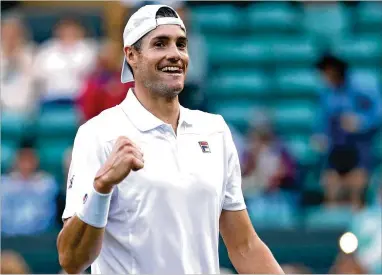  ?? MATTHEW STOCKMAN / GETTY IMAGES ?? John Isner celebrates after defeating Milos Raonic in four sets Wednesday at Wimbledon. Isner next faces Kevin Anderson, who beat Roger Federer in five sets. Rafael Nadal and Novak Djokovic meet up in the other semi.