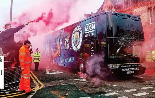  ?? REX ?? Under attack: a can of drink is hurled towards the City team coach and fans let off flares on the corner of Anfield Road