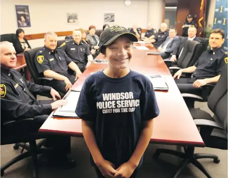  ?? JASON KRYK ?? Grade 6 student Nia Robert is all smiles after being named Chief for the Day at the city’s police headquarte­rs on Thursday.