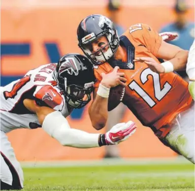  ??  ?? The Broncos’ Paxton Lynch, pictured being hit by Falcons outside linebacker Vic Beasley in the rookie quarterbac­k’s lone start of the season Oct. 9, was in full command of the offense Wednesday. Associated Press file