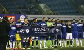  ?? Photograph: Michael Zemanek/BPI/Shuttersto­ck ?? Millwall and QPR players stand together in a show of solidarity before their Championsh­ip draw at the Den.