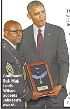  ??  ?? Command Sgt. Maj. Louis Wilson accepts Johnson’s award.