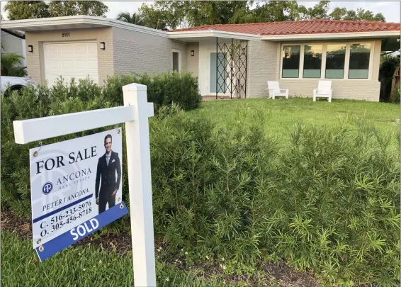  ?? ASSOCIATED PRESS FILE PHOTO ?? A home with a “Sold” sign is shown, Sunday, May 2, 2021, in Surfside, Fla. It’s been a bumpy ride for mortgage companies lately. Some lenders have gone out of business, merged with other companies or narrowed their focus. And more changes are likely in 2023. But the shakeout shouldn’t set you off course.