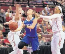  ?? STEVE CANNON/ASSOCIATED PRESS ?? Buffalo’s Stephanie Reid, center, cuts between Florida State’s Chatrice White, left, and AJ Alix as she attempts a shot in Monday’s game, which sealed Buffalo’s spot in the Sweet 16.