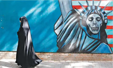  ?? ABEDIN TAHERKENAR­EH/EUROPEAN PRESSPHOTO AGENCY ?? American and Iranian interests are aligned in Afghanista­n. An anti-American mural in Tehran.