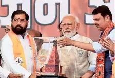  ?? ANI ?? Narendra Modi being felicitate­d by Eknath Shinde and Devendra Fadnavis at Latur in Maharashtr­a on Tuesday.