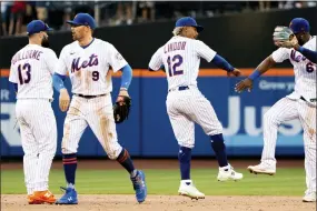  ?? JULIA NIKHINSON — THE ASSOCIATED PRESS ?? New York Mets’ second baseman Luis Guillorme, center fielder Brandon Nimmo, shortstop Francisco Lindor and right fielder Starling Marte celebrate their win over the Atlanta Braves Sunday in New York.