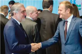  ??  ?? BRUSSELS: European Council President Donald Tusk, right, shakes hands with Afghanista­n’s Chief Executive Abdullah Abdullah during a Conference on Afghanista­n yesterday. — AP