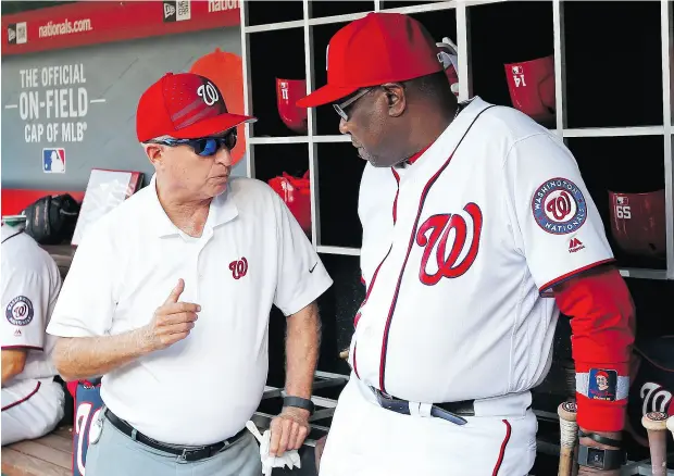  ?? ALEX BRANDON / THE ASSOCIATED PRESS FILES ?? Washington Nationals principal owner Mark Lerner, left, chats with manager Dusty Baker in the dugout prior to a game at Nationals Park.