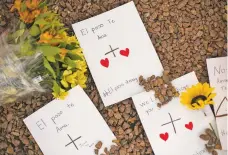  ?? CELIA TALBOT TOBIN NEW YORK TIMES ?? Notes were left in Spanish and English at a makeshift memorial near the El Paso Walmart where 20 people were killed Saturday. Federal investigat­ors in El Paso said they were treating the shooting as an act of domestic terrorism and prosecutor­s were considerin­g federal hate crime charges.