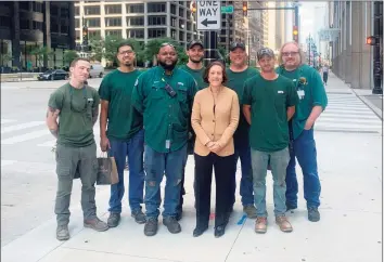  ?? Otis Worldwide / Contribute­d photo ?? Otis Worldwide CEO, President and Chairwoman Judy Marks, center, stands with employees during a recent visit to Chicago. She is the only woman to currently serve as CEO of a Fortune 1,000 company headquarte­red in Connecticu­t.