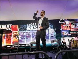  ?? The Associated Press ?? ■ Eric Trump, son of former President Donald Trump, raises a fist as he arrives to speak on stage on Aug. 12 during the Reawaken America Tour at Cornerston­e Church in Batavia, N.Y.