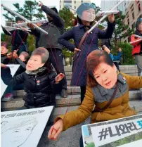  ?? AFP ?? Protesters wearing masks of South Korean President Park GeunHye and her confidante Choi Soon-Sil perform before a candle-lit rally in Seoul on Saturday. —