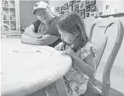  ??  ?? Amanda Shiller goes over her daughter Samantha’s homework in their Magnolia home. After losing her job, Shiller rationed her pills due to lack of insurance.