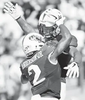  ?? STEPHEN M. DOWELL/TNS ?? UCF wide receiver Gabriel Davis, top, celebrates with wide receiver Otis Anderson after Davis caught a touchdown pass against Pitt.