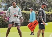 ?? Susan Stocker/TNS ?? Miami Dolphins cornerback Byron Jones, left, pictured rehabbing last June, tweeted Saturday about why he could never suit up in the 2022 season.