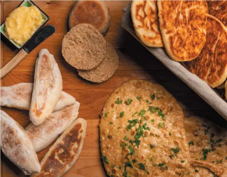  ?? CITIZEN NEWS SERVICE PHOTO ?? These easy summer flatbreads can be made in no time – and with no oven. They are, from left, stovetop shotis, English muffins, soft beer flatbreads and 30-minute naan.