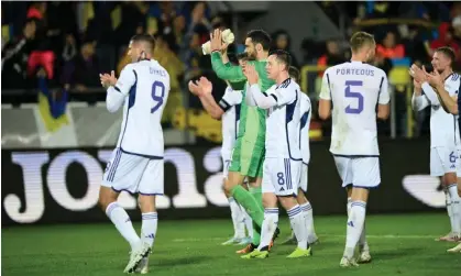  ?? Photograph: Rafal Oleksiewic­z/PA ?? Scotland players applaud the travelling support in Krakow after their draw with Ukraine