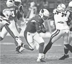  ??  ?? The Cardinals’ David Johnson breaks a tackle against the Chargers in the first half Saturday at University of Phoenix Stadium in Glendale.