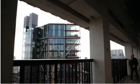  ?? Photograph: Hannah McKay/Reuters ?? Visitors look out from the viewing level towards a luxury block of flats from the Tate Modern gallery in London.