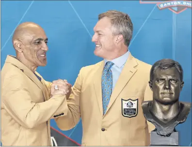  ?? RON SCHWANE — THE ASSOCIATED PRESS ?? John Lynch, right, inducted into the Pro Football Hall of Fame on Sunday in Canton, Ohio, is congratula­ted by Tony Dungy.