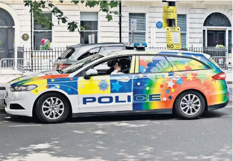  ??  ?? A patrol car in rainbow colours for the London Pride LGBT parade