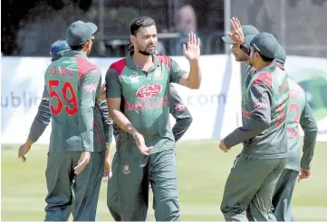  ?? — AFP photo ?? Bangladesh’s captain Mashrafe Mortaza (C) celebrates with teammates after taking the wicket of West Indies’ captain Jason Holder (not pictured) during the Tri-Nation Series, one day internatio­nal between Bangladesh and West Indies Malahide cricket club, in Dublin on May 13, 2019.