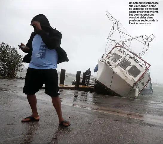  ?? PHOTOS AFP ?? Un bateau s’est fracassé sur le rebord en béton de la marina de Watson Island proche de Miami. Les dommages sont considérab­les dans plusieurs secteurs de la Floride.