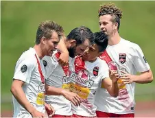  ??  ?? Canterbury United players celebrate a Stephen Hoyle (second from left) goal during their match against the Wellington Phoenix reserves at Newtown Park.
