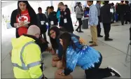  ?? RECORDER PHOTO BY JAMIE A. HUNT ?? From front left: Sean Roberts, Imperial Ambulance Paramedic Director, oversees Westfield students Faith Mora, 11, and Jazlin Amigon, 12, as they perform hands-only CPR on a dummy last year at the PUSD Pathways exhibition at Portervill­e Military Academy.