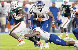  ?? BRYNN ANDERSON/AP ?? Miami running back DeeJay Dallas carries the ball as Savannah State defensive back Isaiah Bennett attempts the tackle during Saturday’s game.