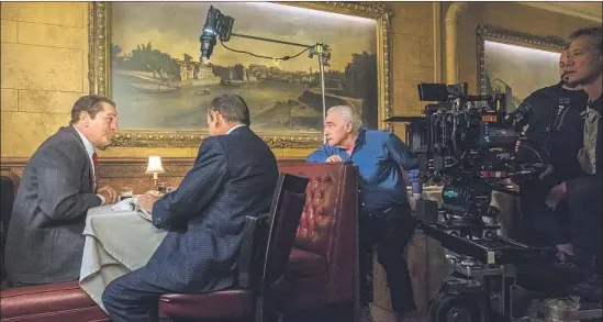  ?? Photograph­s by Niko Tavernise Netf lix ?? MARTIN SCORSESE, center, directs a scene in “The Irishman.” Call it a eulogy from the filmmaker on the characters and crimes he’s made indelible to cinema.