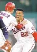  ?? ALEX BRANDON/AP ?? The Nationals’ Juan Soto and Trea Turner celebrate after Soto hit a game-winning single in the ninth inning Tuesday for Opening Day in Washington.