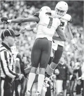  ?? DEAN HARE/AP ?? Arizona receiver Cayleb Jones (1) and quarterbac­k Anu Solomon celebrate after connecting for a touchdown against Washington State in the second quarter on Saturday in Pullman, Wash.
