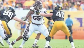  ?? MISSISSIPP­I STATE ATHLETICS ?? Mississipp­i State offensive lineman Greg Eiland blocks Iowa defenders in last year’s Outback Bowl. Eiland plays in memory of his best friend, Josten Baxstrum, who died on Nov. 24, 2018.