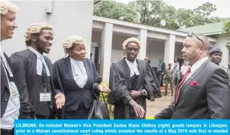  ??  ?? LILONGWE: Re-instated Malawi’s Vice President Saulos Klaus Chilima (right) greets lawyers in Lilongwe, prior to a Malawi constituti­onal court ruling which annulled the results of a May 2019 vote that re-elected the then incumbent president. — AFP