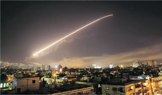 ?? HASSAN AMMAR / THE ASSOCIATED PRESS ?? The Damascus sky lights up with surface-to-air missile fire as the U.S., U.K. and France launched an attack on Syria.
