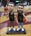  ?? Sue Ogrocki/Associated Press ?? A bobblehead of Cleveland natives Travis and Jason Kelce stands on the Cavs’ court Sunday in Cleveland. The team will give the bobblehead­s to fans at a game on Tuesday.