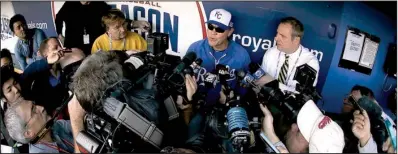  ?? AP/CHARLIE RIEDEL ?? Kansas City Royals Manager (center) Ned Yost talks to reporters before his team’s practice Friday. The Royals will be looking to win their first World Series title since 1985 when they take on the San Francisco Giants, starting Tuesday.