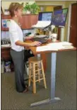  ?? DIGITAL FIRST MEDIA FILE PHOTO ?? Rose Walters makes use of her new standup desk in her office at the Pottstown Health Foundation. She is able to stand or sit which makes for a better working health benefit in the office environmen­t.