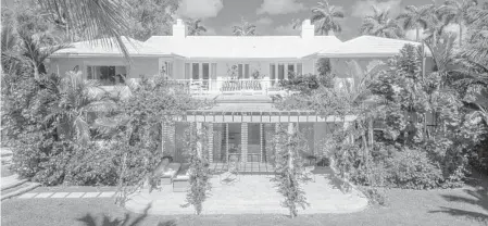  ?? PHOTOS BY RICHARD NOVAK/COURTESY ?? The 9,187-square-foot home at 2555 Lake Ave., Miami Beach features seven bedrooms, eight bathrooms, one half-bath, a detached guest house, gym, master suite, heated saltwater pool, a summer kitchen and a private dock with about 150 feet of water...