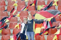  ?? — AFP ?? German supporters lift flags in the stands ahead of a friendly between Oman and Germany at the Sultan Qaboos Sports Complex stadium in Muscat.