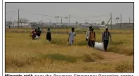  ?? (AP/Petros Karadjias) ?? Migrants walk near the Pournara Emergency Reception center, in Kokkinotri­mithia, on April 18 on the outskirts of the capital Nicosia, Cyprus.