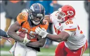  ?? DUSTIN BRADFORD / Getty Images ?? The Broncos’ Melvin Gordon , left, tries to elude the Chiefs’ Chris Jones during the fourth quarter Sunday in Denver.