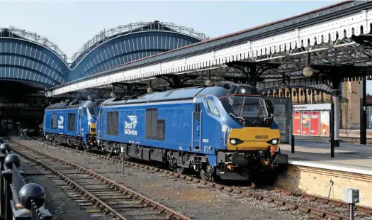  ?? RON COVER. ?? Two Class 68s destined for TransPenni­ne Express (68032 and 68027) leave York on June 11, with the 0800 driver training trip to Scarboroug­h. TPE reinvented itself as an inter-city operator, but quickly found capacity was a problem, hampered by continual changes in plans on the route by Government. The diesel ‘68s’ will haul coaches across the Pennines, on a route once planned to be electrifie­d.