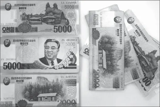  ?? The Associated Press ?? CURRENCY CONUNDRUM: A portrait of the late Kim Il Sung is seen on the 5,000 bill of the North Korean won. While foreign brand-name goods are often paid for in U.S. dollars, Euros or Chinese yuan, and priced accordingl­y at the official exchange rate,...